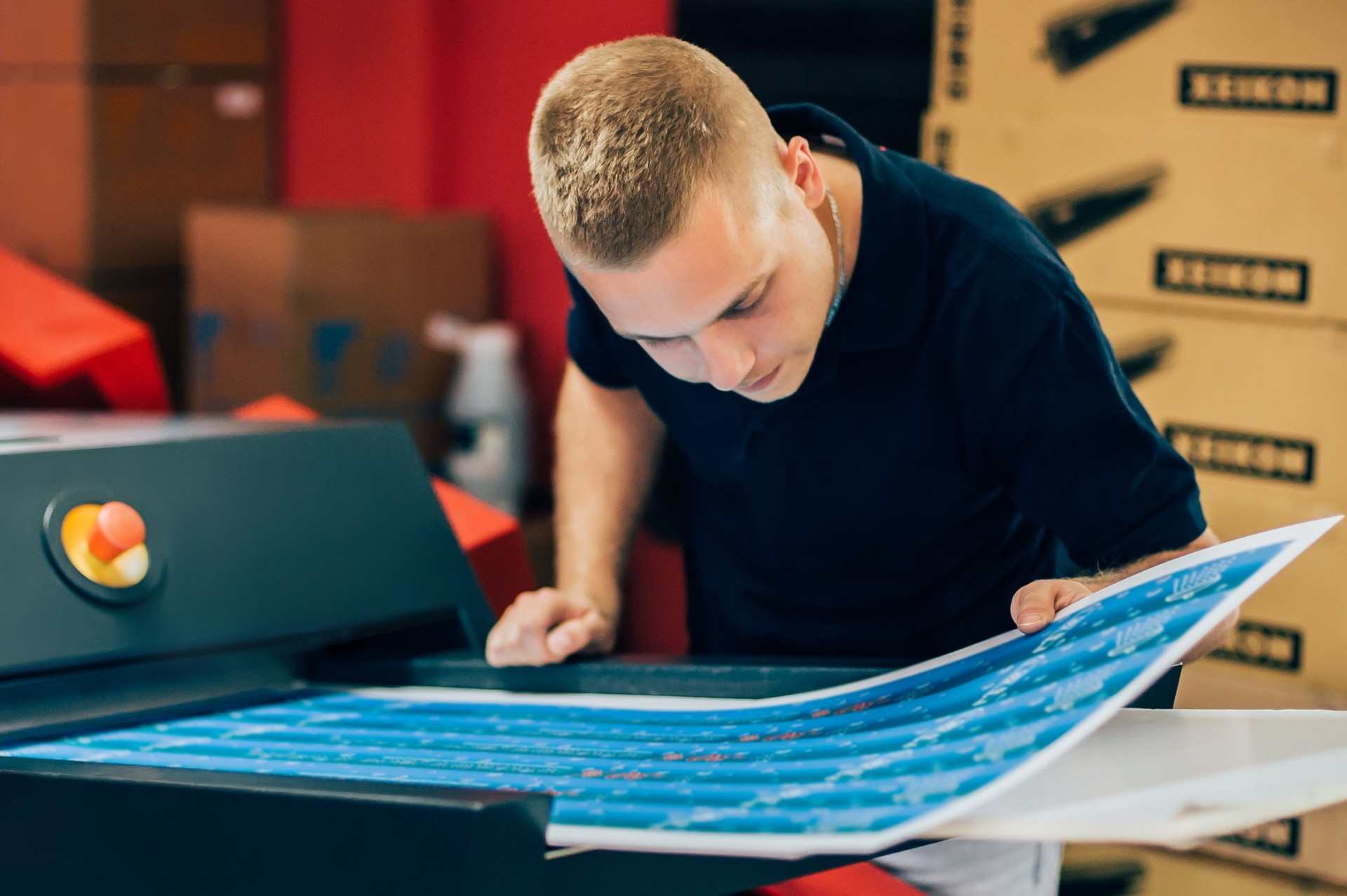 Young man working in printing factory